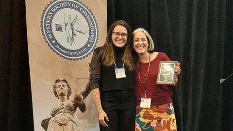 UCI alumna and Western Society of Criminology Vice President Jennifer Macy, left, congratulates Professor Keramet Reiter for winning the June Morrison-Tom Gitchoff Founders Award. Photo by Jon Gould